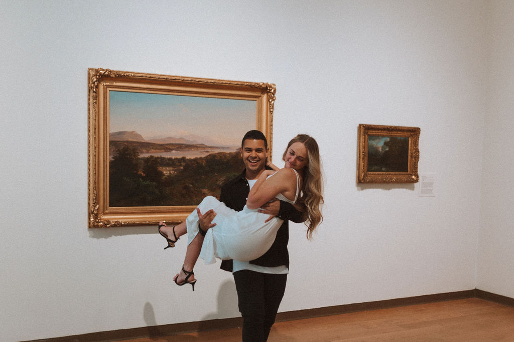 a couple posing at the orlando art museum for a photoshoot
