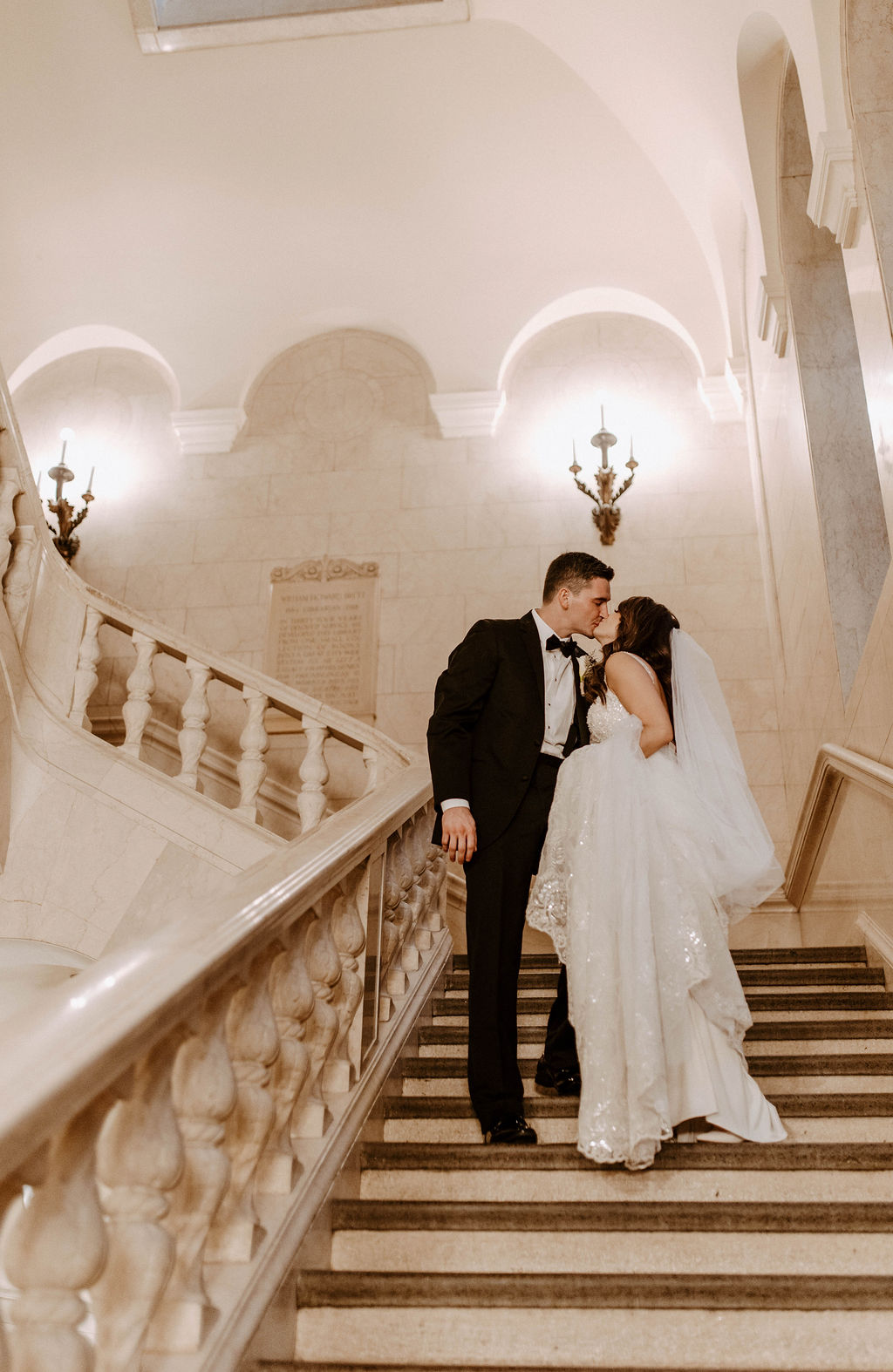couple posing on the stairs in a church for their wedding in cleveland