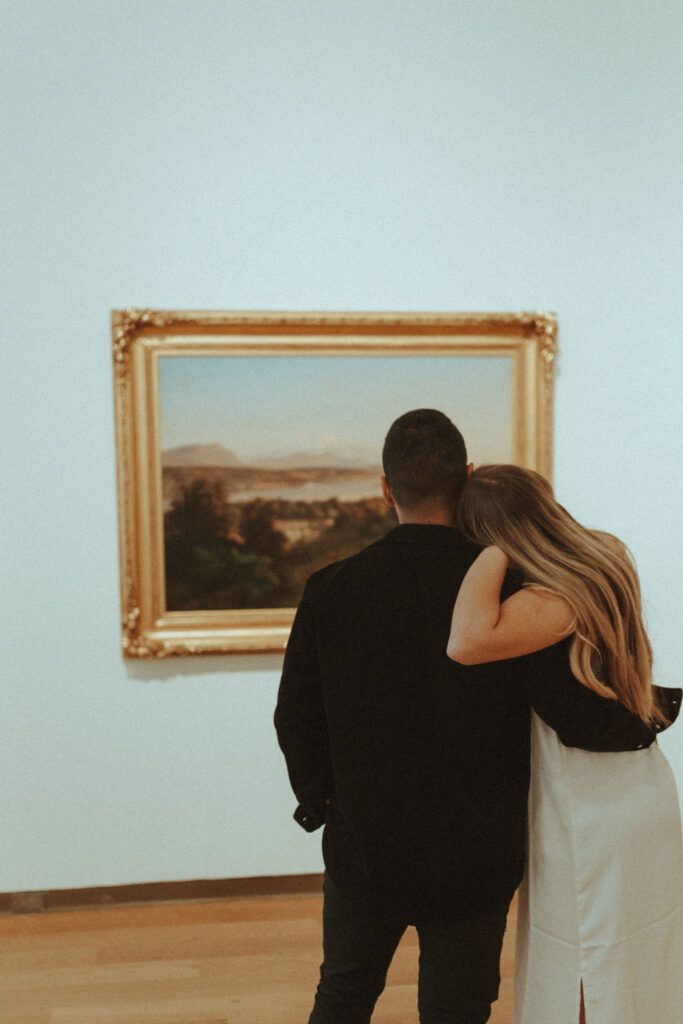 a photo of a couple posing in front of art at an art gallery in orlando | Vintage Style Art Museum Photoshoot in Orlando