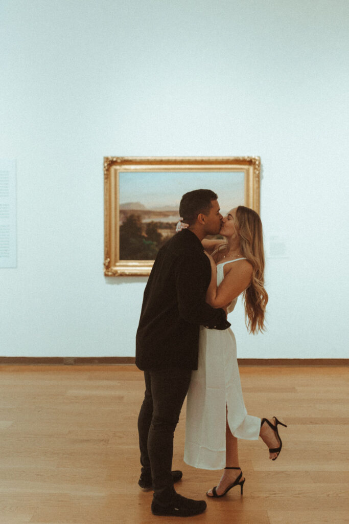 a photo of a couple posing in front of art at an art gallery in orlando