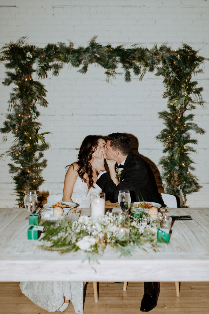 bride and groom kissing during their wedding reception