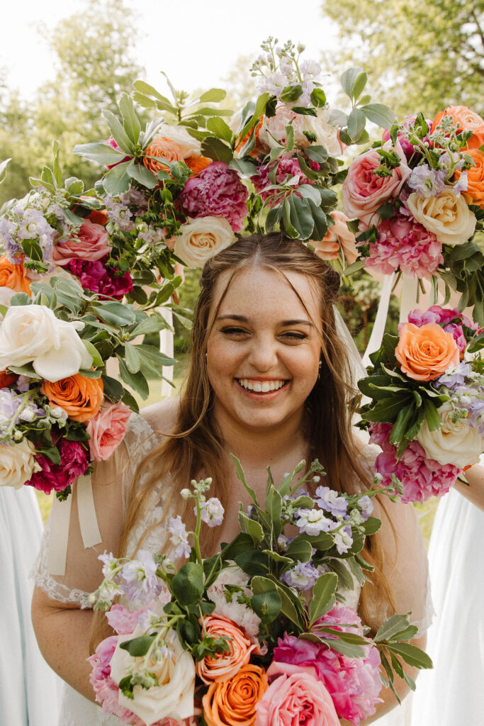 bride surrounded by bridal bouquets