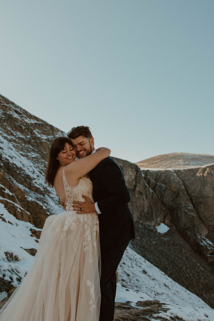 couple posing in the colorado mountains for their post wedding photoshoot
