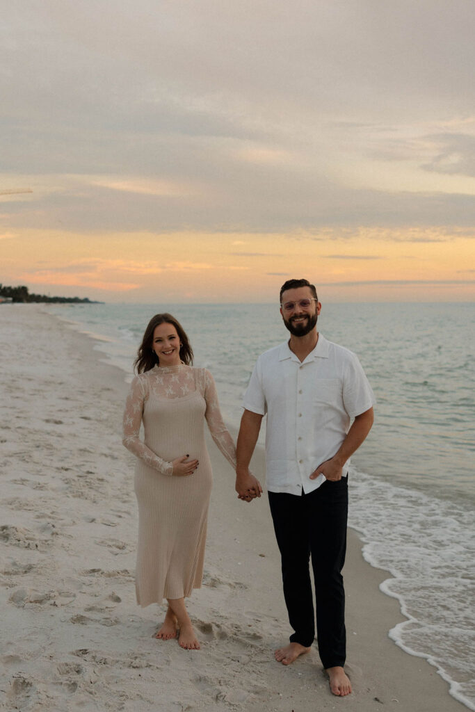 Couple at their baby announcement shoot at Naples Beach