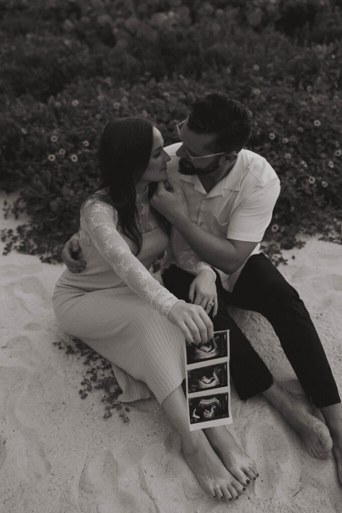 black and white picture of the couple holding their baby ultrasound