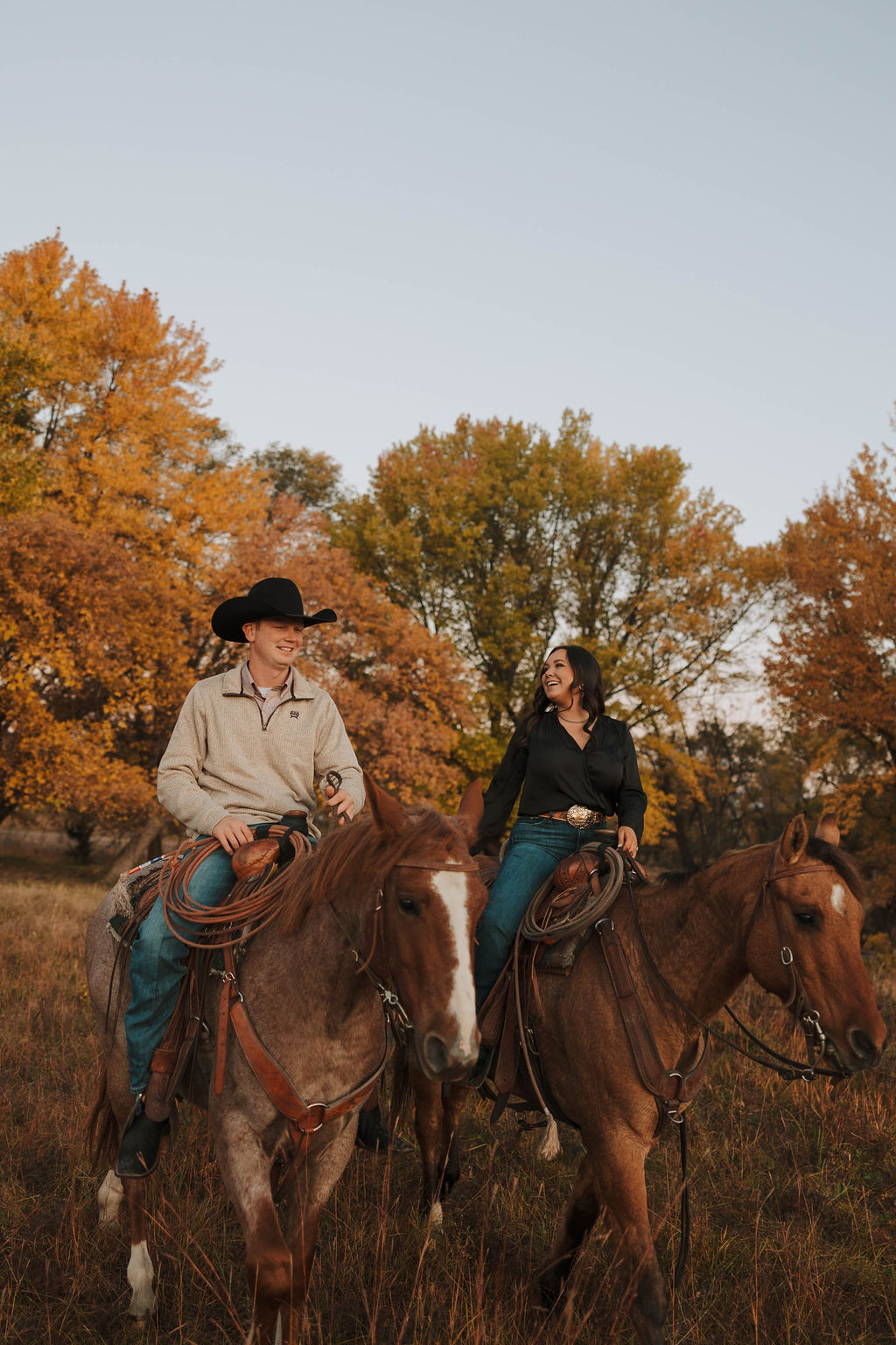 newly engaged couple riding their horses during their country western engagement session