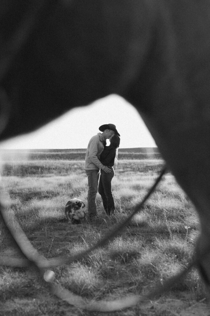 couple kissing during their country western engagement session