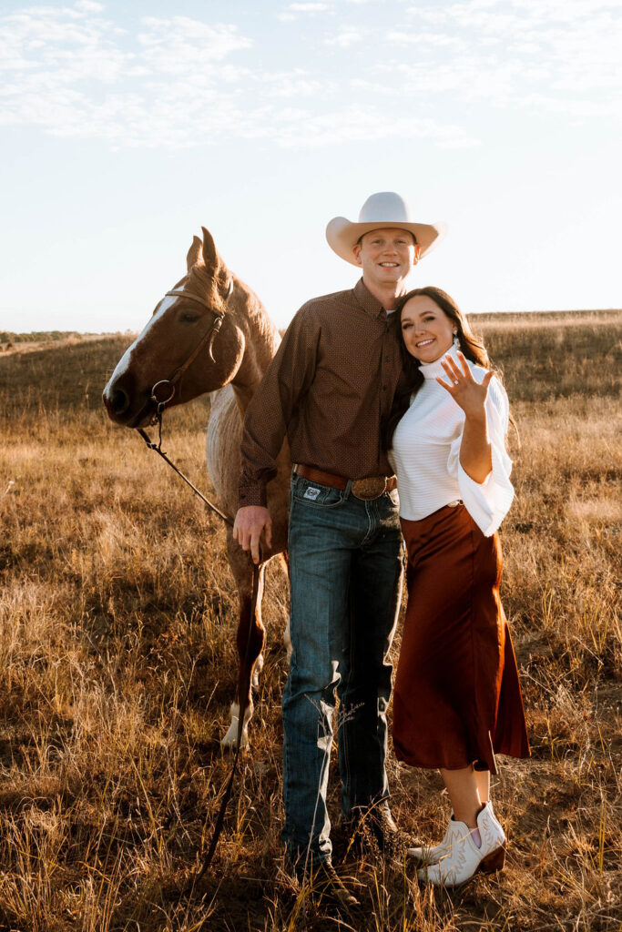 stunning couple showing their rings during their country western engagement session