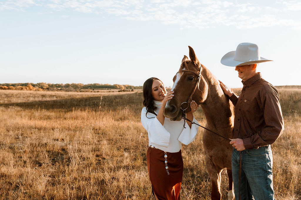 couple during their country engagement session with their horse